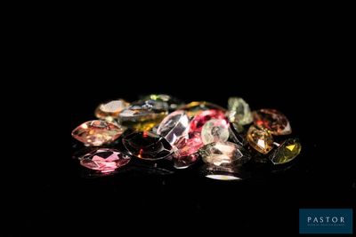 some very pretty colored diamonds on a black surface