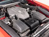 the engine of a red car with its hood open
