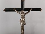a silver and black crucif with a cross on top of it