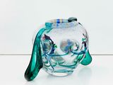 a glass vase with a fish inside of it on a table