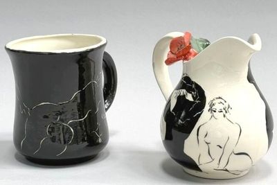 two black and white vases with designs on them