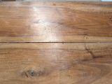 a close up of a wooden table with a knife on it