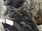 a pile of luggage that is wrapped in plastic