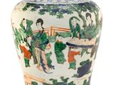 a vase with a painting on it on a white surface