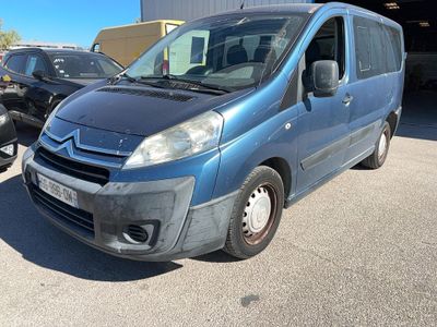 a blue van parked in a parking lot next to other cars