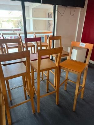 tables and chairs in a room with red walls and a flat screen tv