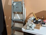 a ladder that is leaning against a wall next to a table