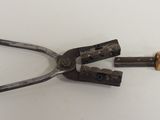 a pair of pliers that are laying on a table