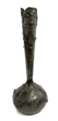 a black vase that is sitting on a white surface