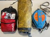 a bag, rope, and other items laid out on a table