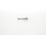 a close up of a ring with blue sapphires on a white surface