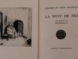 an open book with a picture of a man sitting in a chair