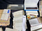 many mails and envelopes sitting on a table