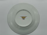 a white plate with a picture on it sitting on a table