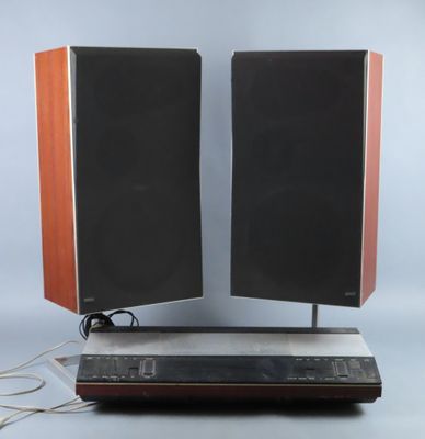 two speakers that are on top of a speaker stand