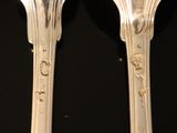 two forks that are sitting next to each other on a table