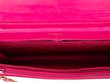 a close up of a pink purse on a white surface