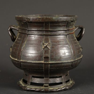 a large metal pot that is on a stand