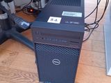 a dell computer sitting on the floor next to a chair