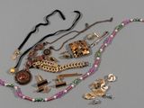 a lot of jewelry that is laying out on the table