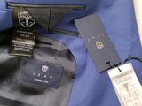 a close up of a blue jacket with a tag on it