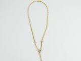 a gold necklace with a cross on a white background