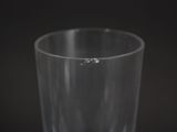 a close up of a glass with water in it on a table