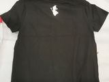 black t - shirt with white logo on the chest and red sleeves