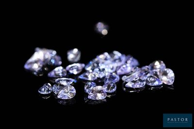 some very pretty blue diamonds on a black surface