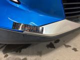 a close up of a blue car with a sticker on it