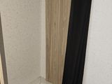 a closet with a black curtain and a wooden floor