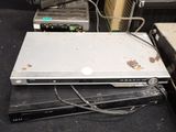 a laptop computer sitting on top of a dvd player