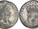 a silver coin with a crown on top of it