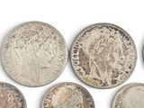 six different types of silver coins are shown on a white surface