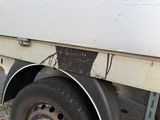 a close up of a flatbed truck with a flat tire