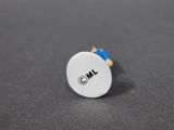 a close up of a small white button on a gray surface