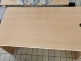 a wooden table with two wine glasses on top of it