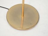a table lamp with a gold base and a black cord