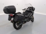 a black motorcycle parked in a white room