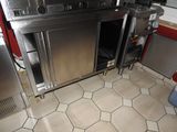 a kitchen with a stove, oven, and cabinets in it