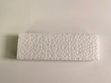 a white piece of paper on a table next to a toothbrush