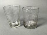 two glasses sitting next to each other on a table