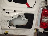 a white car with a broken door and a broken window