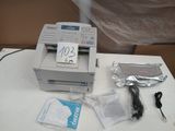 a printer sitting on a table with a price tag on it