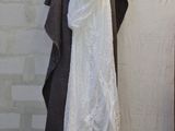 a white dress hanging on a ladder next to a wall