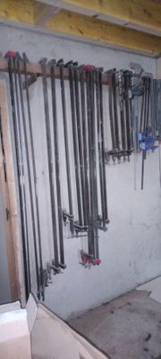 many tools hanging on the wall in the garage