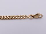 a gold chain bracelet with a clasp on a white background