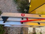 a ladder that has a red handle on it