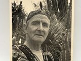 an old black and white photo of a man with a hat on