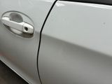 a close up of a car door handle with a sticker on it
